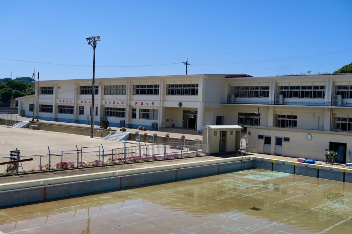 School in background, swimming pool in foreground
